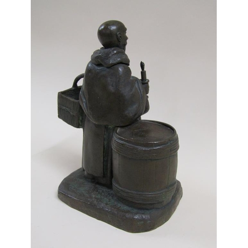 24 - A 19c style patinated bronze figure group of the Merry Monk, he carrying candle and basket, standing... 