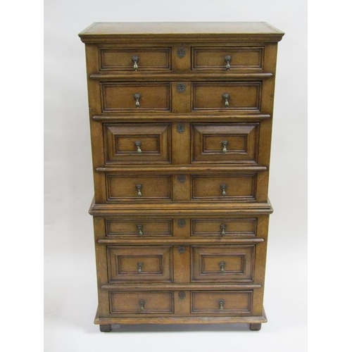 251 - A late 17c/early 18c style oak chest on chest, the upper section with two short and three long gradu... 