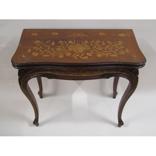 258 - A 19c mahogany fold over card table with profuse marquetry decoration, supported on shaped and mould... 