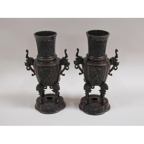 27 - A pair of late 19c Oriental patinated censer vases, two handled and having four legs supported on lo... 