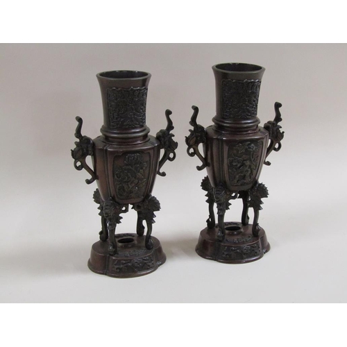 27 - A pair of late 19c Oriental patinated censer vases, two handled and having four legs supported on lo... 