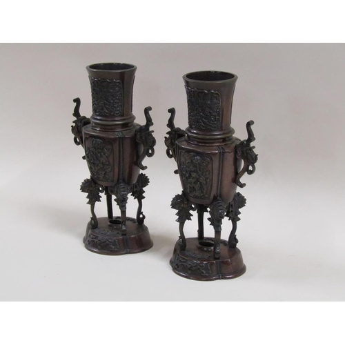 27 - A pair of late 19c Oriental patinated censer vases, two handled and having four legs supported on lo... 