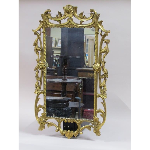 292 - An 18c style gilt wood wall mirror, the frame scroll and leaf carved with rose mounts, 89cm x 53cm.