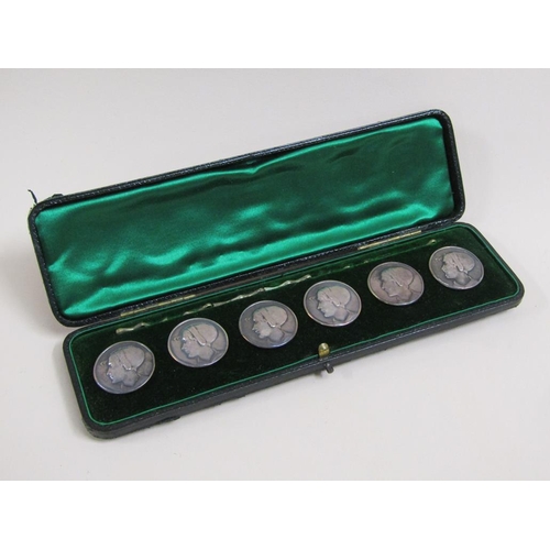 38 - A boxed set of six Art Nouveau silver buttons, embossed and chased with the head of a lady wearing a... 