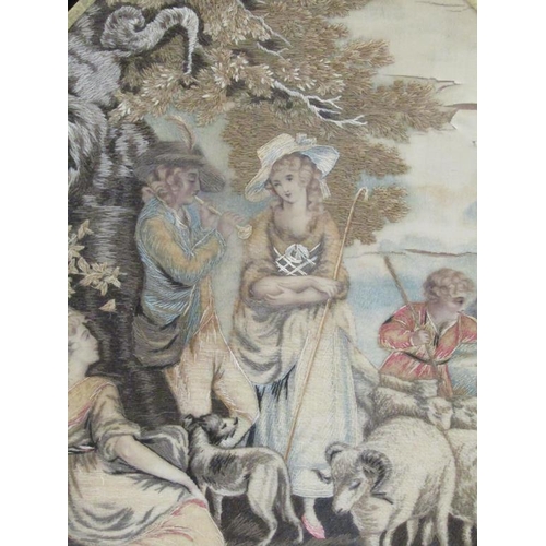 157 - An early 19c silk work picture of a piper under a tree together with two ladies and a passing flock ... 