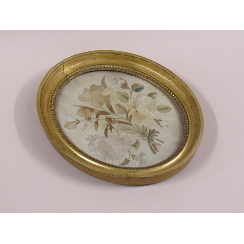 164 - A 19c silk work picture of a bouquet of flowers, oval framed and glazed, 21cm x 17cm.