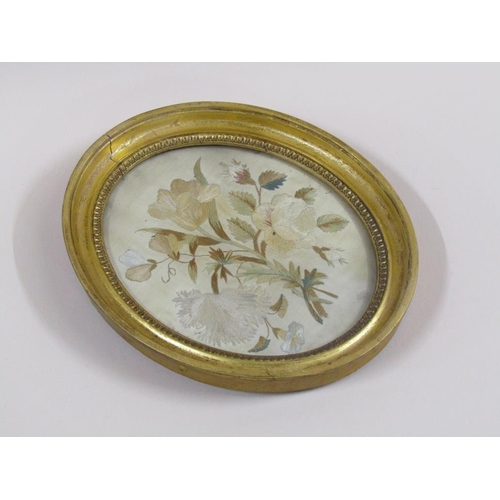 164 - A 19c silk work picture of a bouquet of flowers, oval framed and glazed, 21cm x 17cm.