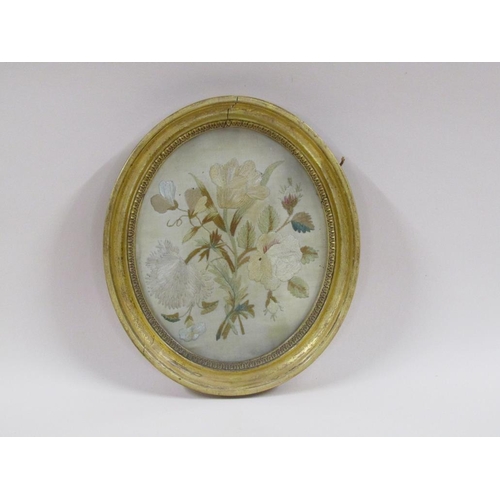 164 - A 19c silk work picture of a bouquet of flowers, oval framed and glazed, 21cm x 17cm.