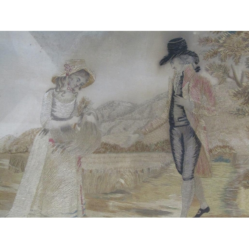 167 - An early 19c silk work picture of a lady and gentleman in a corn field, oval framed and glazed, 29cm... 