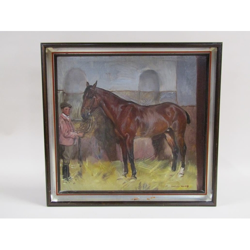 214 - Ludwig Koch - Horse in stable with stable lad, signed oil on board, framed, 46cm x 49cm.