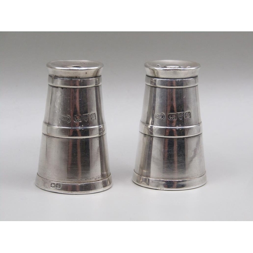 73 - A pair of silver miniature milk churn condiments, pepper and salt, Chester 1920, 4cm h.