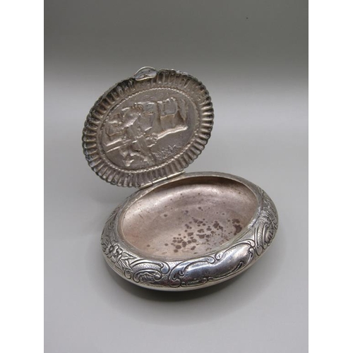 78 - An Edwardian Dutch tobacco box of oval form embossed and chased, the lid with a panel of cattle unde... 