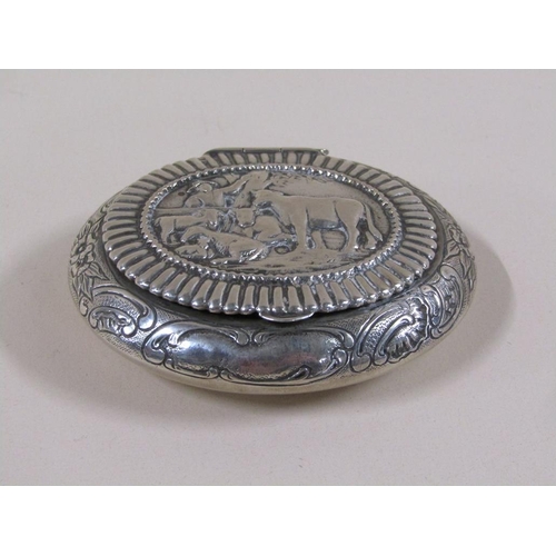 78 - An Edwardian Dutch tobacco box of oval form embossed and chased, the lid with a panel of cattle unde... 