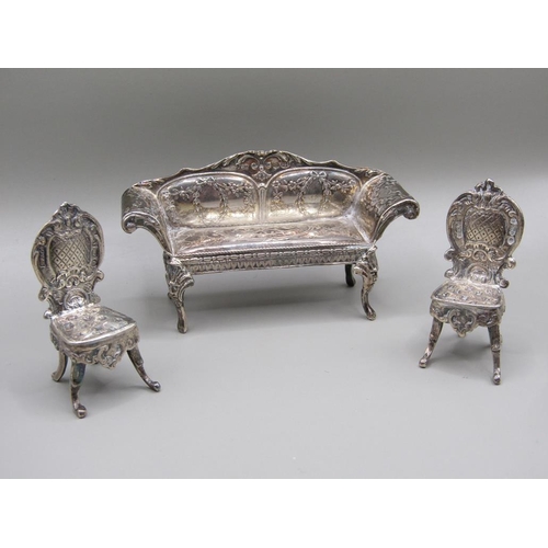 79 - An early 20c Continental silver miniature two seater sofa with scrolling arms and cabriole legs and ... 