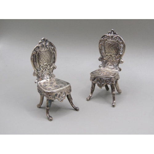 79 - An early 20c Continental silver miniature two seater sofa with scrolling arms and cabriole legs and ... 