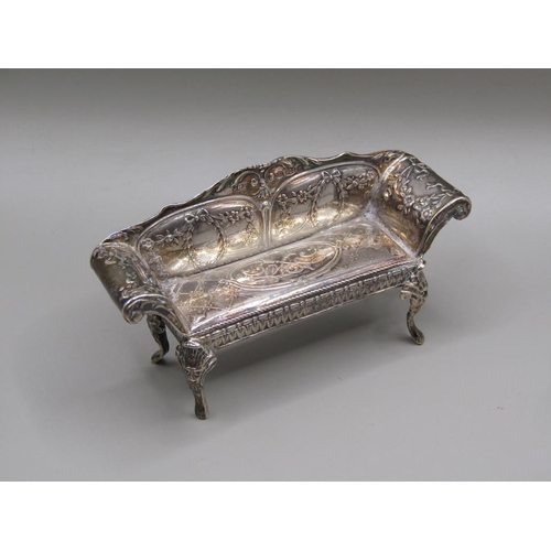 79 - An early 20c Continental silver miniature two seater sofa with scrolling arms and cabriole legs and ... 