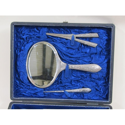 100 - A Japanese silver vanity set in travelling case by Zeewo, c.1925/30, comprising a hand mirror, three... 