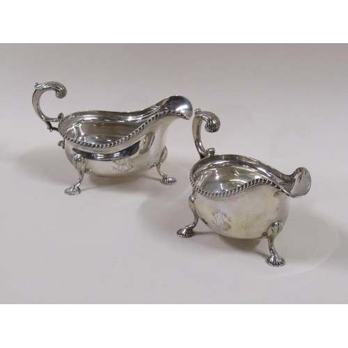 101 - A pair of Mappin & Webb Georgian style sauce boats with open double scroll handles, cast gadroon rim... 