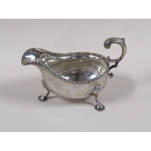 101 - A pair of Mappin & Webb Georgian style sauce boats with open double scroll handles, cast gadroon rim... 