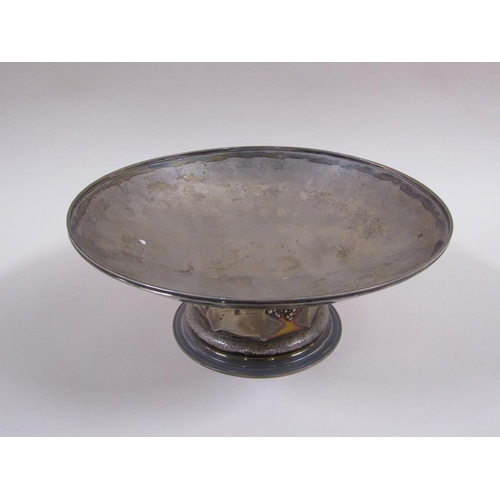 102 - A silver fruit bowl of circular dish form, on a facet base with fruiting vine embossing and circular... 