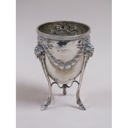 105 - A pair of silver cups on stands, the cups of ovoid form cast with garland and bow, the legs having r... 