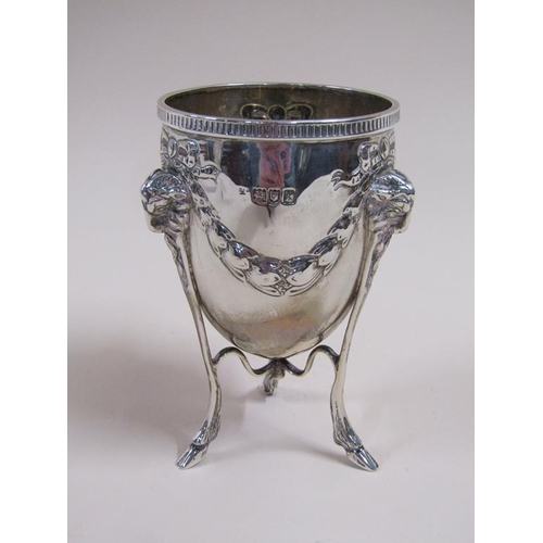 105 - A pair of silver cups on stands, the cups of ovoid form cast with garland and bow, the legs having r... 