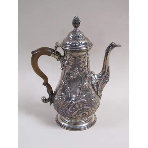 109 - An 18c silver coffee pot of baluster form, embossed and chased with later decoration, London 1767/8,... 