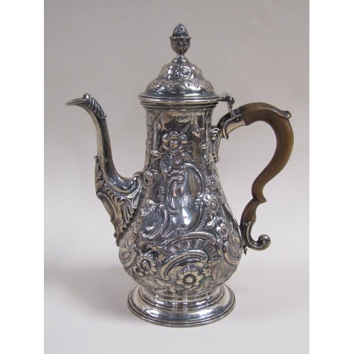 109 - An 18c silver coffee pot of baluster form, embossed and chased with later decoration, London 1767/8,... 