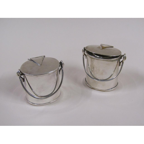 114 - A pair of early 20c silver plate milk churn vesta pots, each 7cm h.