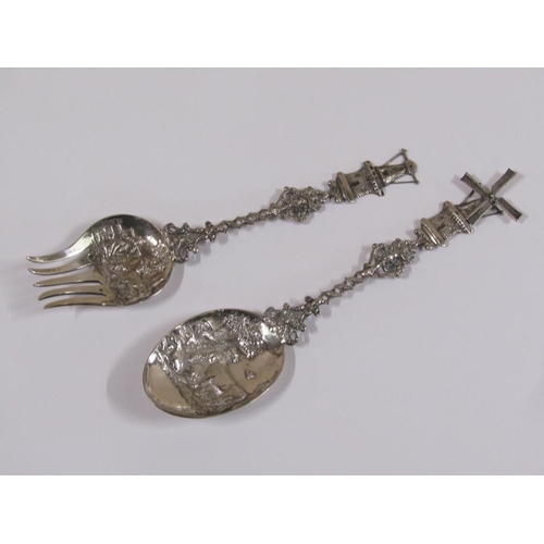 85 - A pair of early 20c Dutch silver decorative table spoons, the bowls embossed and chased with dairy c... 