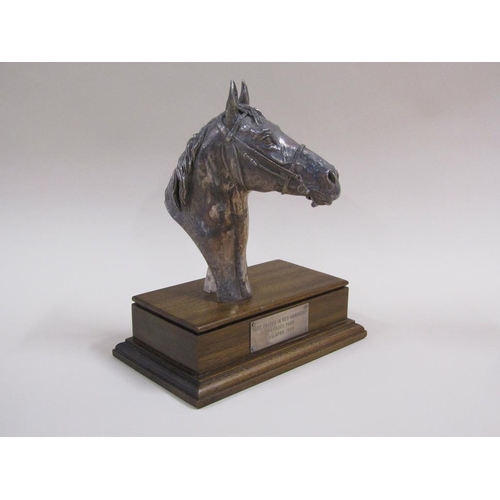 92 - A silver cased horse racing trophy in the form of a horses head, on a mahogany plinth with attached ... 