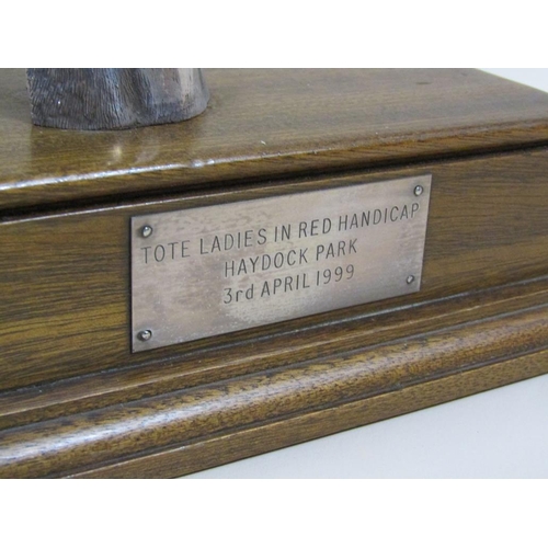 92 - A silver cased horse racing trophy in the form of a horses head, on a mahogany plinth with attached ... 