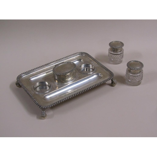 93 - An early 19c silver two bottle ink stand with a central lidded seal box, the stand with two pen tray... 