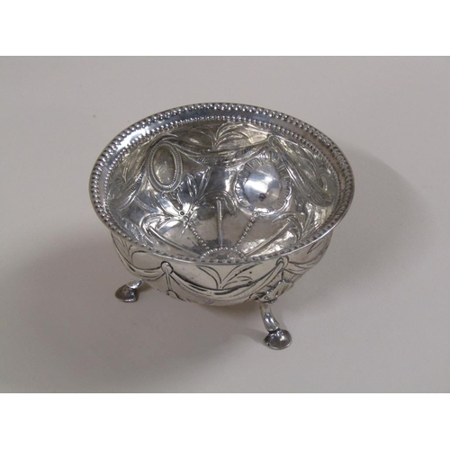 94 - A late Georgian sugar bowl with a parallel beaded upper rim, embossed and chased with garland, bows ... 