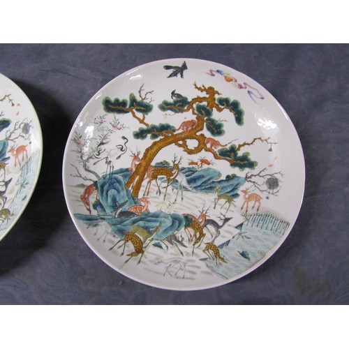 139 - A pair of 19c Chinese famille verte chargers decorated with deer under a pine tree with monkeys and ... 