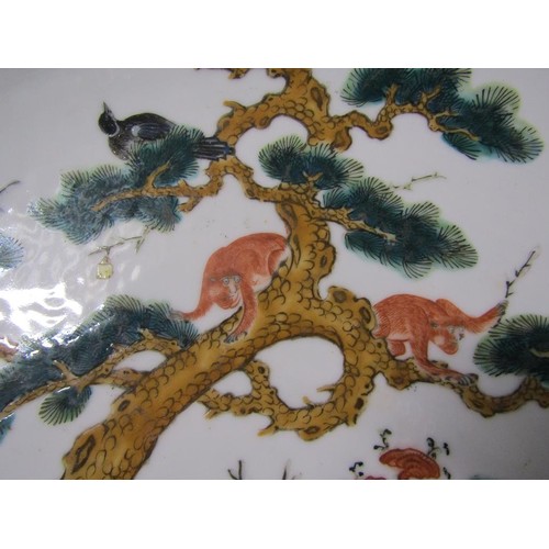 139 - A pair of 19c Chinese famille verte chargers decorated with deer under a pine tree with monkeys and ... 