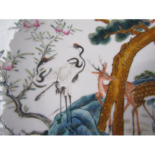 139 - A pair of 19c Chinese famille verte chargers decorated with deer under a pine tree with monkeys and ... 