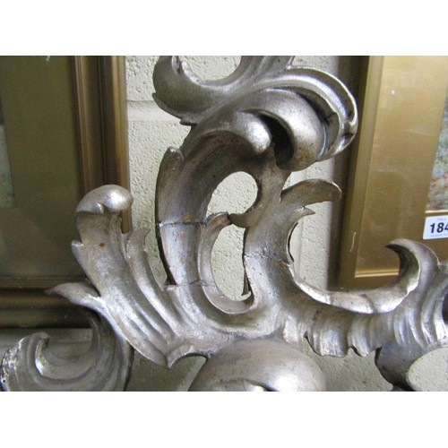 294 - A 19c style Florentine design silvered carved wood scrolling wall mirror,  137cm x 89cm overall.