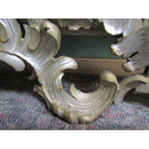 294 - A 19c style Florentine design silvered carved wood scrolling wall mirror,  137cm x 89cm overall.