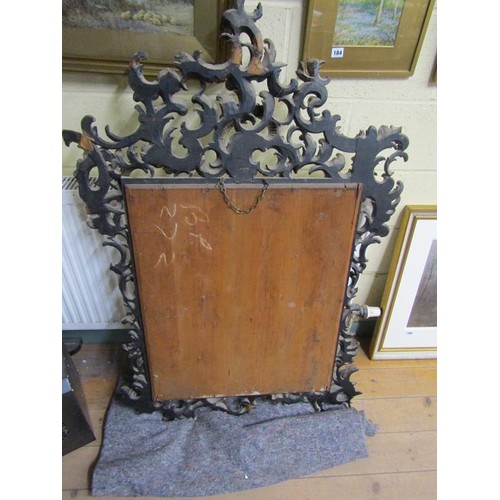 294 - A 19c style Florentine design silvered carved wood scrolling wall mirror,  137cm x 89cm overall.