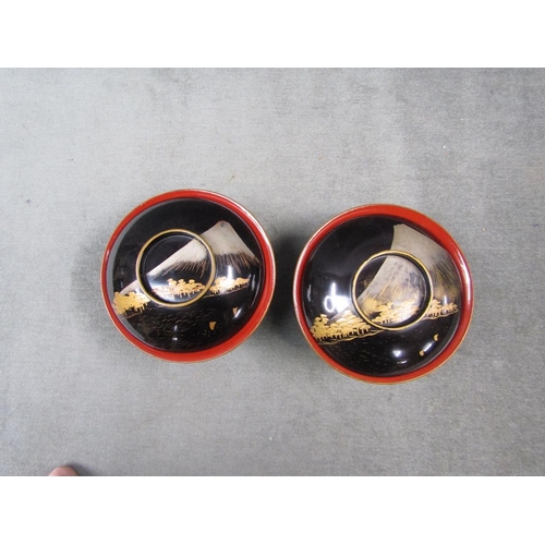 1251 - TWO ORIENTAL BLACK LACQUERED BOWLS AND STANDS, BOWLS 14CM W