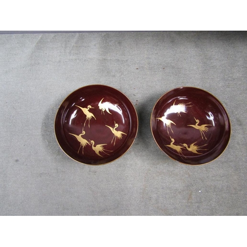 1298 - PAIR OF ORIENTAL LACQUERED BOWLS, GILT DECORATED WITH BIRDS, 11CM W