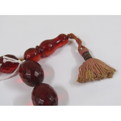 1327 - STRING OF CUT CHERRY AMBER TYPE BEADS, 52CM L