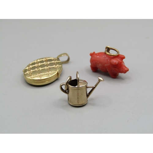 1392 - 9CT GOLD MINIATURE WATERING CAN; PENDANT LOCKET; CARVED CORAL PIG