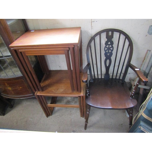 557 - TWO TEAK NEST OF TABLES; WHEEL BACK ARMCHAIR