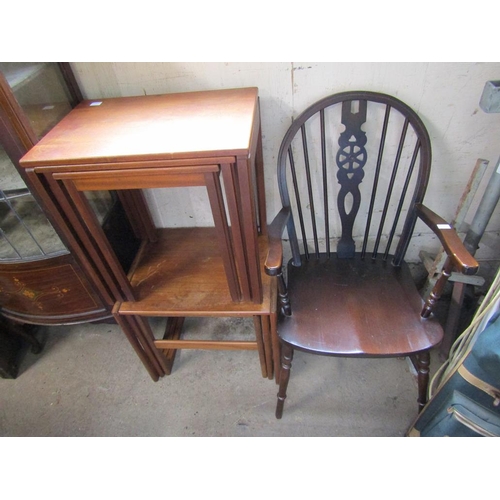 557 - TWO TEAK NEST OF TABLES; WHEEL BACK ARMCHAIR