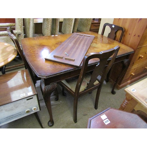 639 - WALNUT VENEERED DINING TABLE AND FOUR CHAIRS