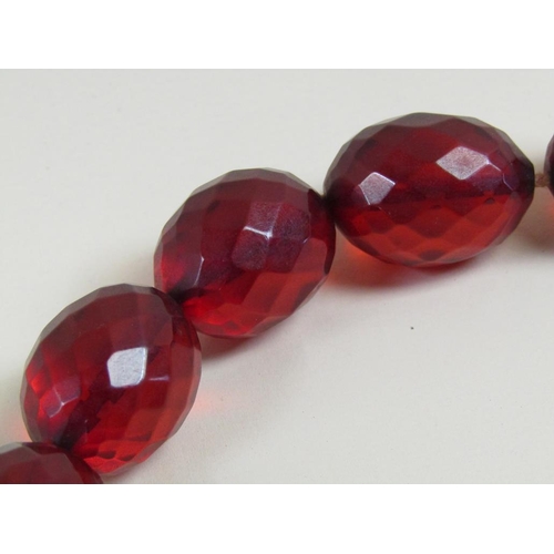 1485 - STRING OF CUT CHERRY AMBER TYPE BEADS