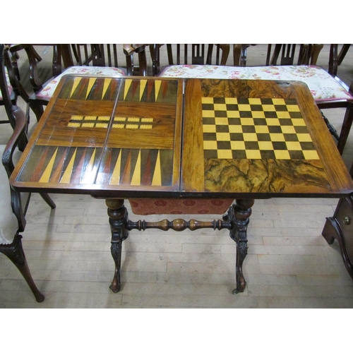 1882 - VICTORIAN FIGURED WALNUT VENEERED METAMORPHIC FOLD OVER GAMES TABLE/NEEDLEWORK BOX ON CARVED REFECTO... 