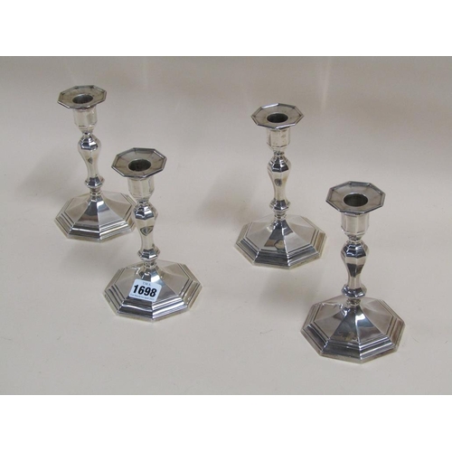 1698 - SET OF FOUR SILVER CASED CANDLESTICKS - 17cms H